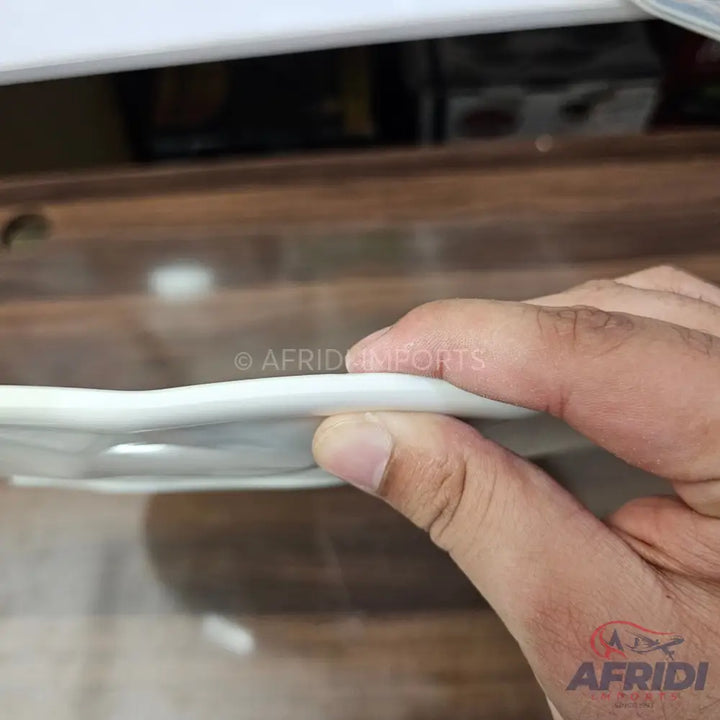 A thin, flexible white silicone seal, likely for a door or window.