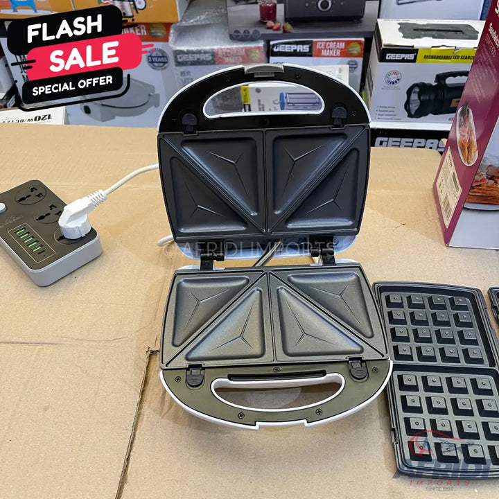 White and black open sandwich maker with interchangeable waffle plates.