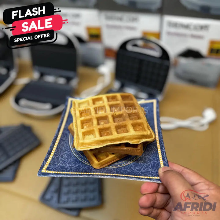 Golden brown, square-shaped waffles stacked on a decorative plate.