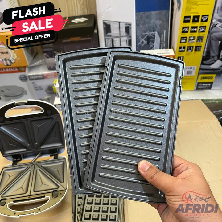 A white sandwich maker with interchangeable grill and waffle plates.