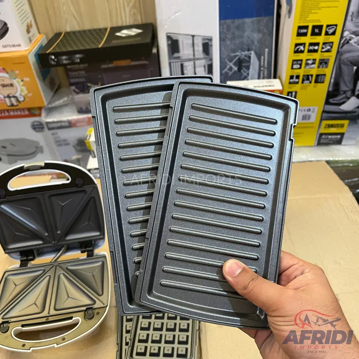 A white sandwich maker with interchangeable grill and waffle plates.