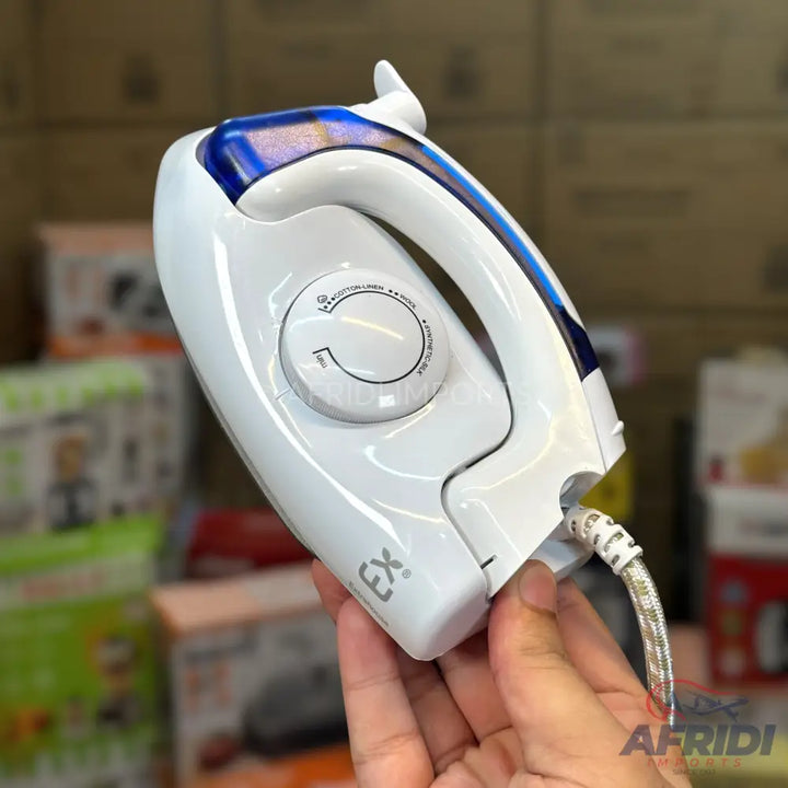A white and blue steam iron with a temperature control dial, designed for various fabric types.