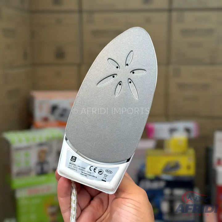 A handheld mini steam iron with a non-stick soleplate and several steam vents.
