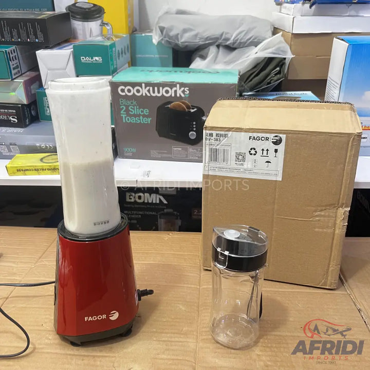 A red personal blender with a clear blending cup, along with an empty, clear spice grinder.