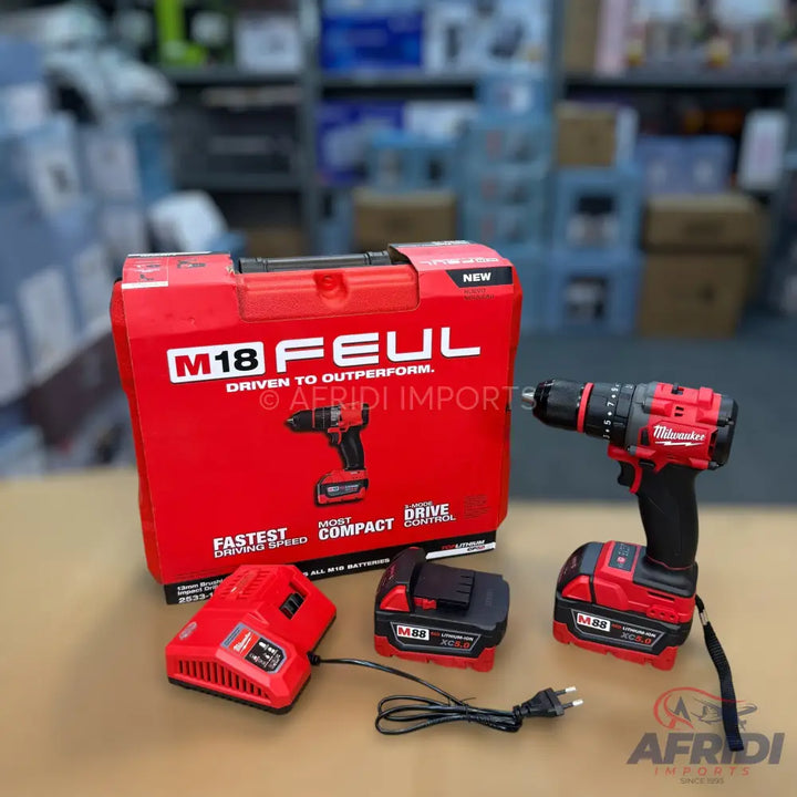 A Milwaukee M18 FUEL cordless drill kit including the drill, two batteries, a charger, and a carrying case.