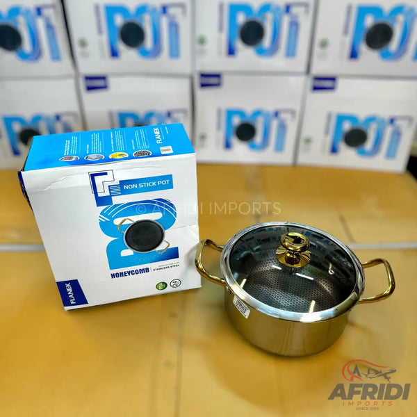 Stainless steel non-stick cooking pot with a glass lid and gold-colored handles.