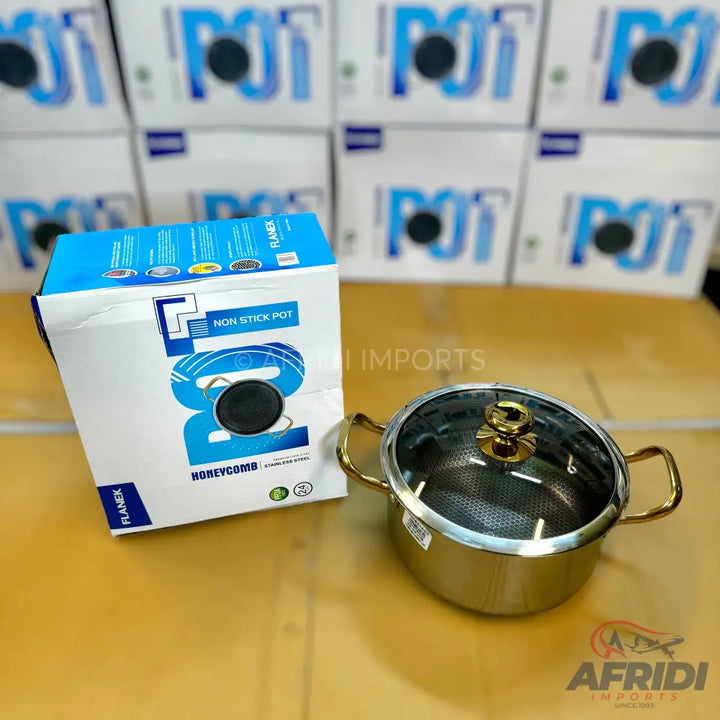 Stainless steel non-stick cooking pot with a glass lid and gold-colored handles.