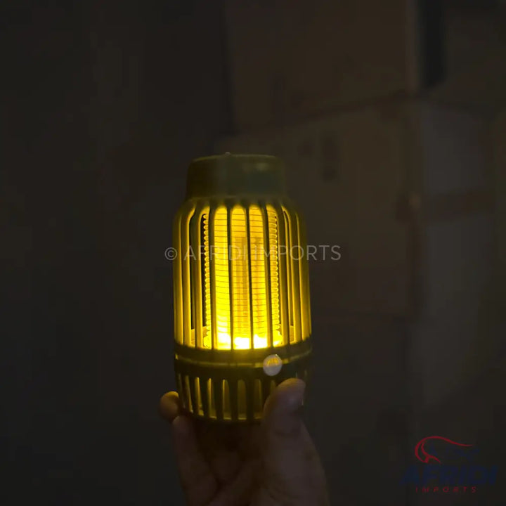 A glowing yellow mosquito zapper.