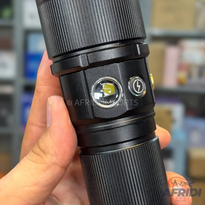 A black tactical flashlight with multiple light modes and a charging port.