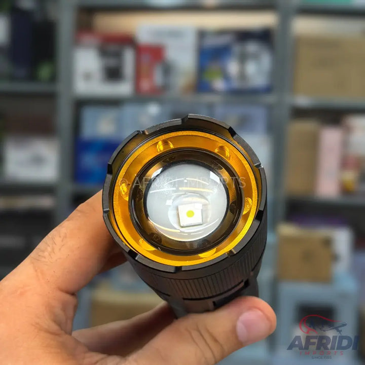 A black flashlight with a bright yellow bezel and a prominent white LED bulb.