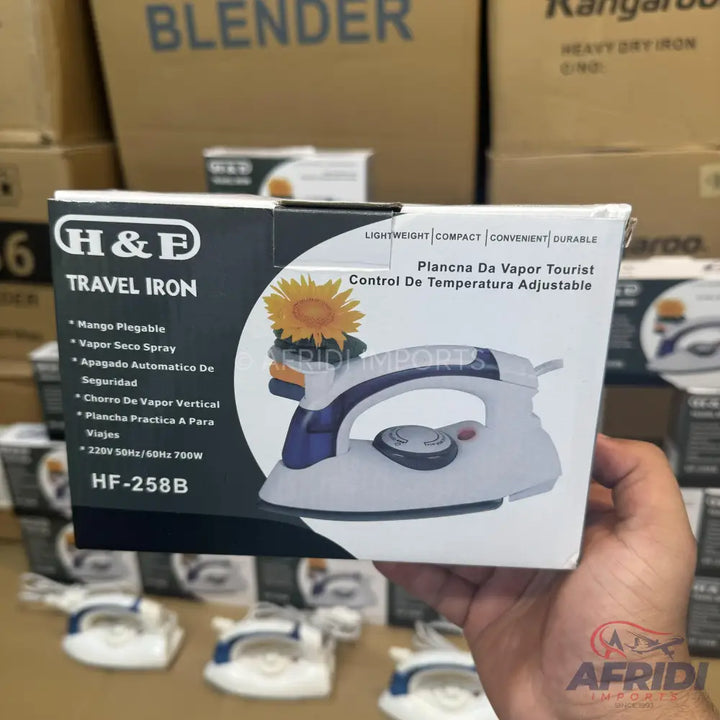 White and purple travel iron with adjustable temperature control.