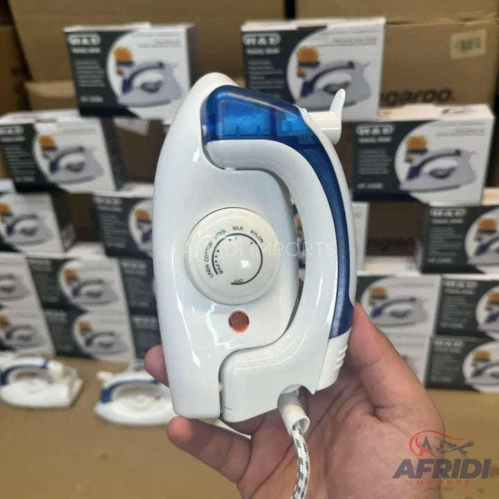 White and blue portable travel iron with temperature control.