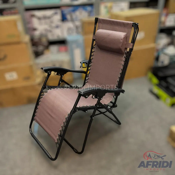 A foldable, zero-gravity reclining chair with a padded headrest and black frame.