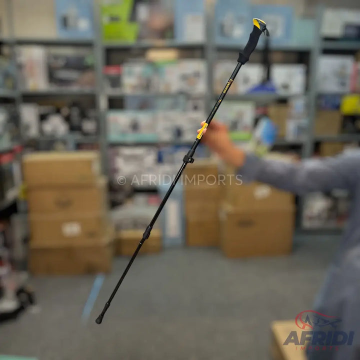 Black adjustable trekking pole with a yellow accent.