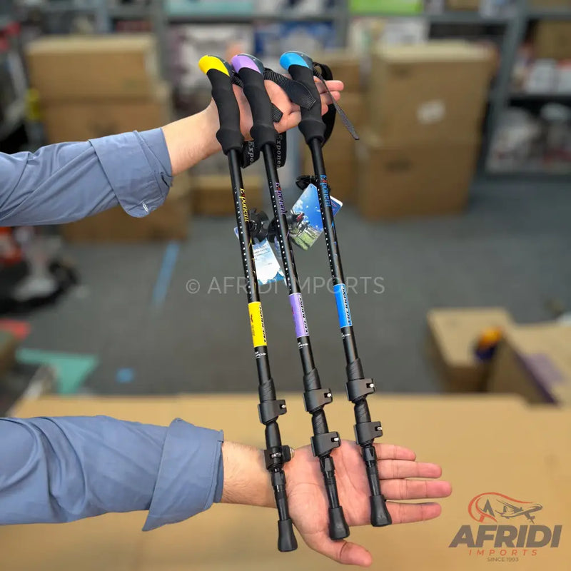 Three adjustable trekking poles with different colored handles.