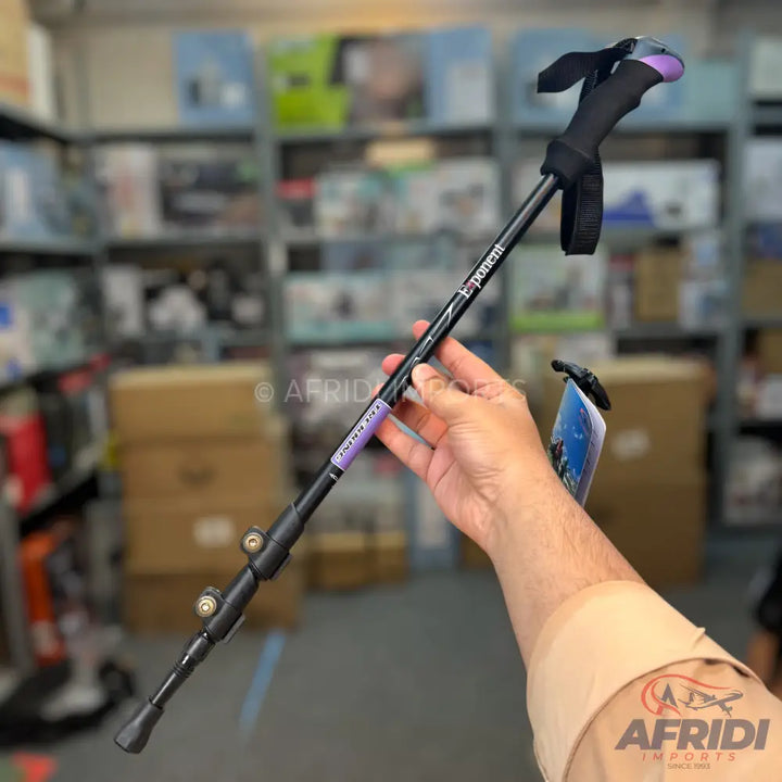 Black and purple collapsible trekking pole with a wrist strap.