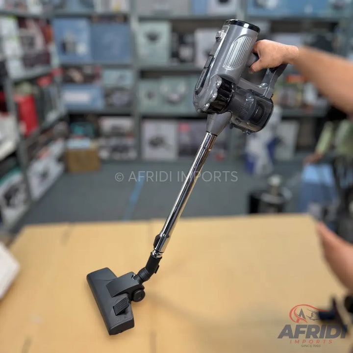 Cordless stick vacuum cleaner with a grey handheld unit and black floor head.