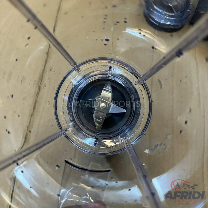 Clear plastic blender jar with a four-pronged blade.