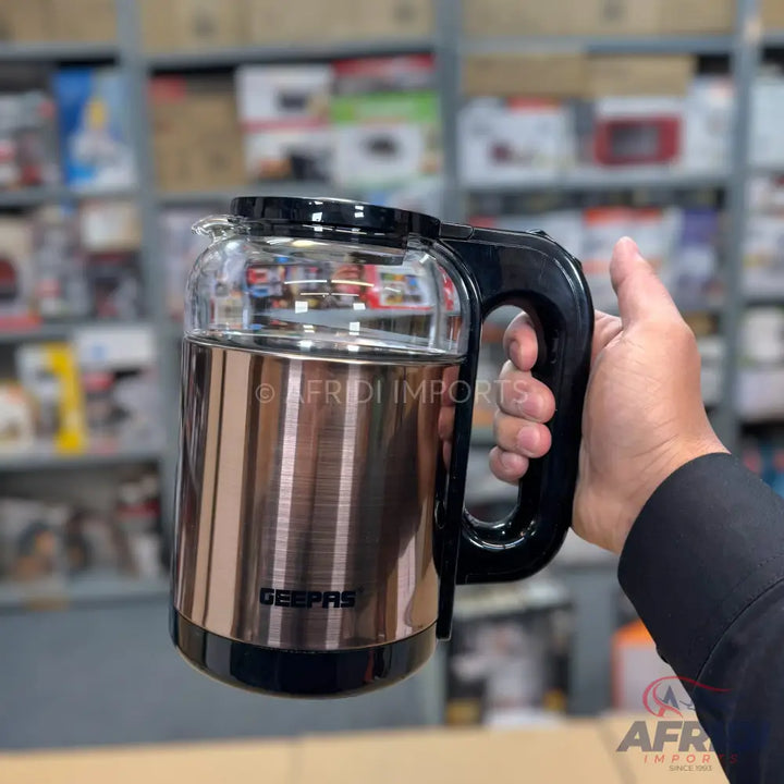 A rose gold and black electric kettle with a clear glass upper body and a black handle.