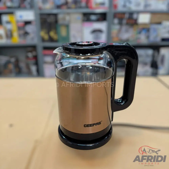 A modern electric kettle with a rose gold base and transparent glass top.