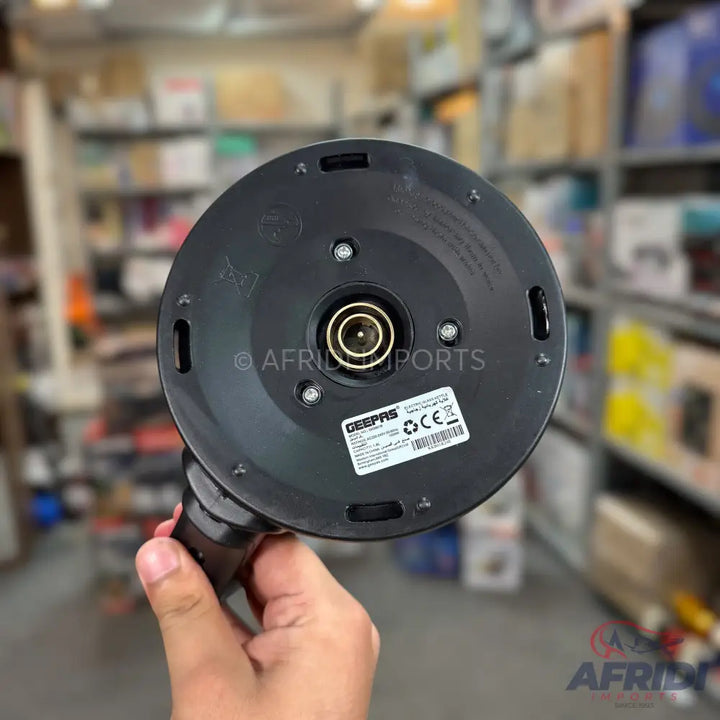 The base of a black electric kettle with a central power connector.