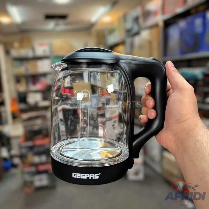 A clear glass electric kettle with a black handle and base.