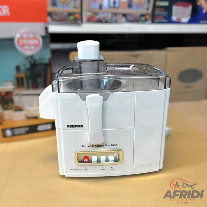 White kitchen juicer with a clear lid and control buttons.