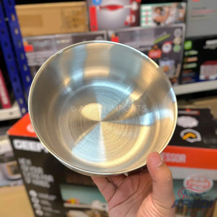 Shiny, brushed stainless steel mixing bowl.