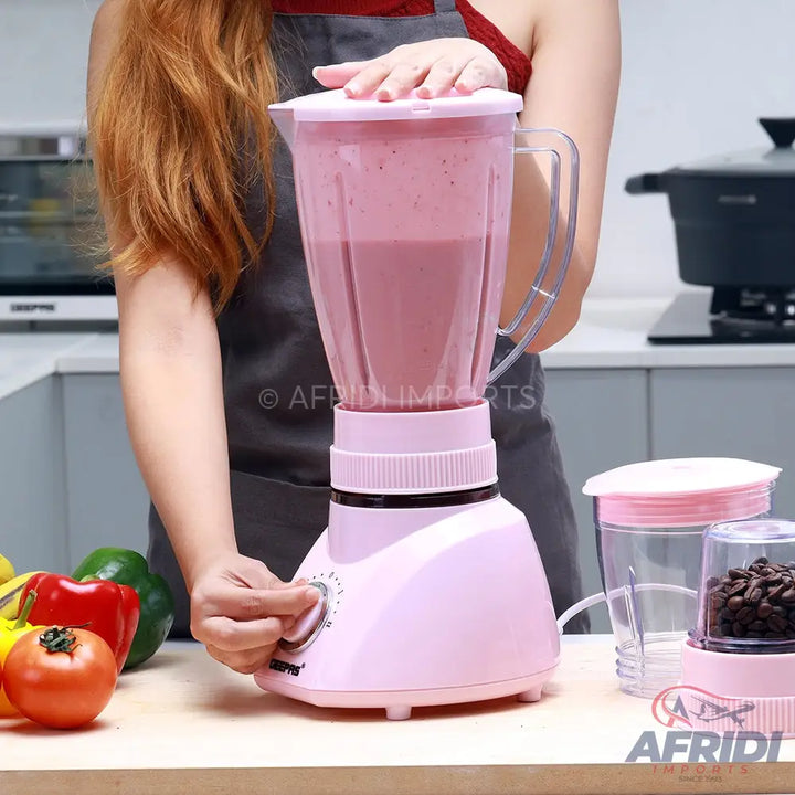 Pink kitchen blender with a clear jar and a separate grinder attachment.