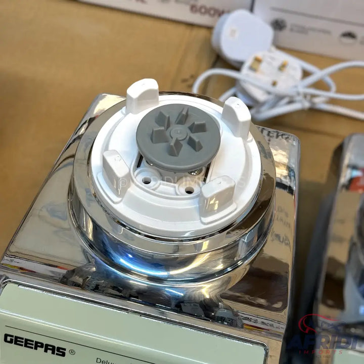 A silver and white blender base with a grey drive shaft for sale.