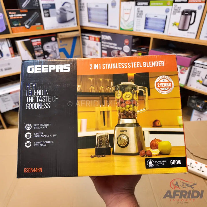A Geepas 2-in-1 stainless steel blender with a 1-liter unbreakable PC jar, 6-piece stainless steel blade, 2-speed control with pulse, and a 600W powerful motor, offering a 2-year warranty.