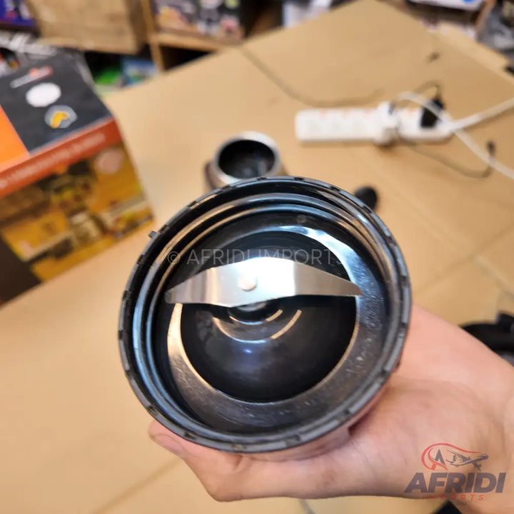 A handheld blender or grinder cup with a two-pronged blade.