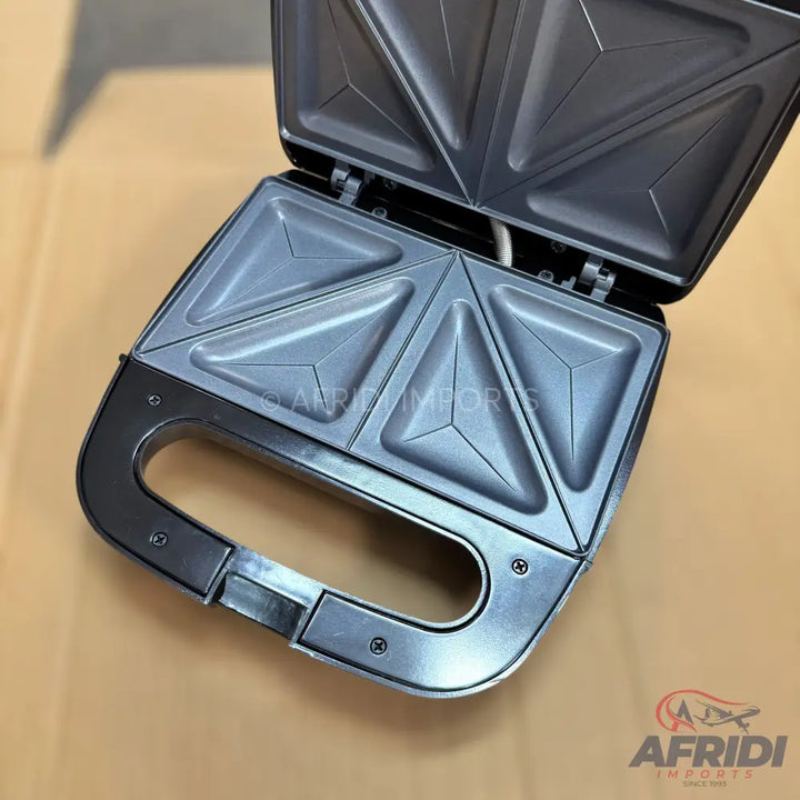 An open sandwich maker with four triangular compartments.
