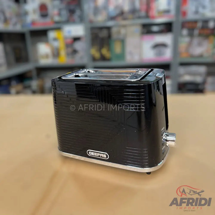 A black, two-slice toaster with a textured finish and chrome accents.