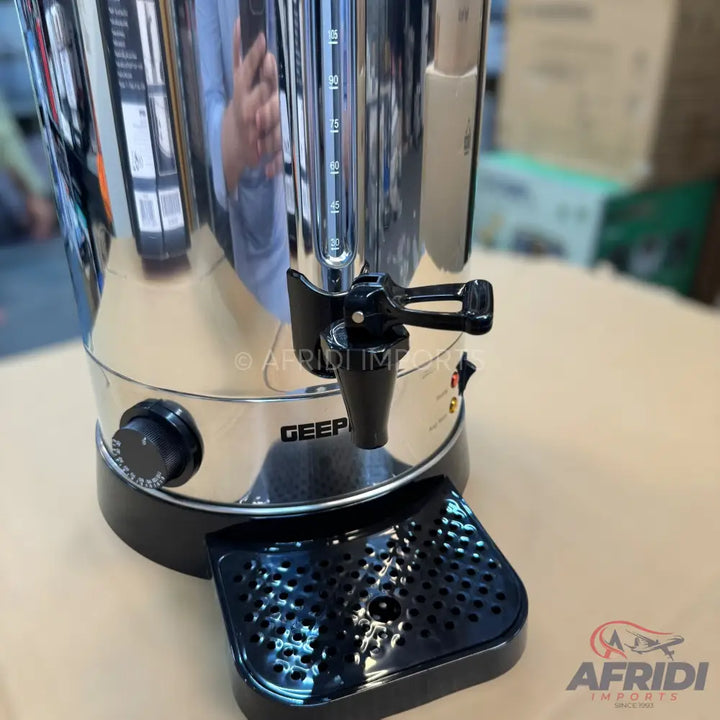 A stainless steel beverage dispenser with a spigot, temperature control dial, and a visible water level indicator.