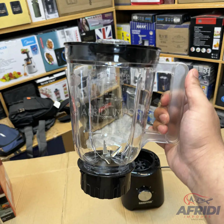 A black and clear plastic blender with a handled pitcher.
