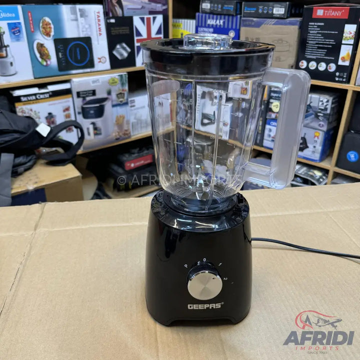 Black blender with a clear plastic pitcher and a silver control knob.