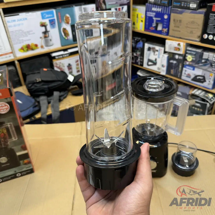 A black blender with three clear blending containers of different sizes.