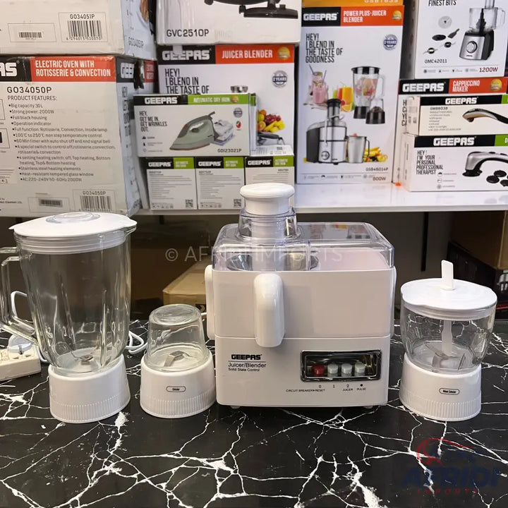 White juicer blender with three attachments.
