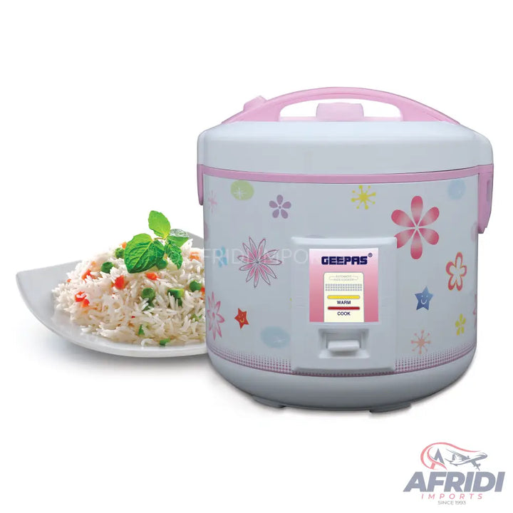 White and pink patterned rice cooker with a plate of cooked rice.