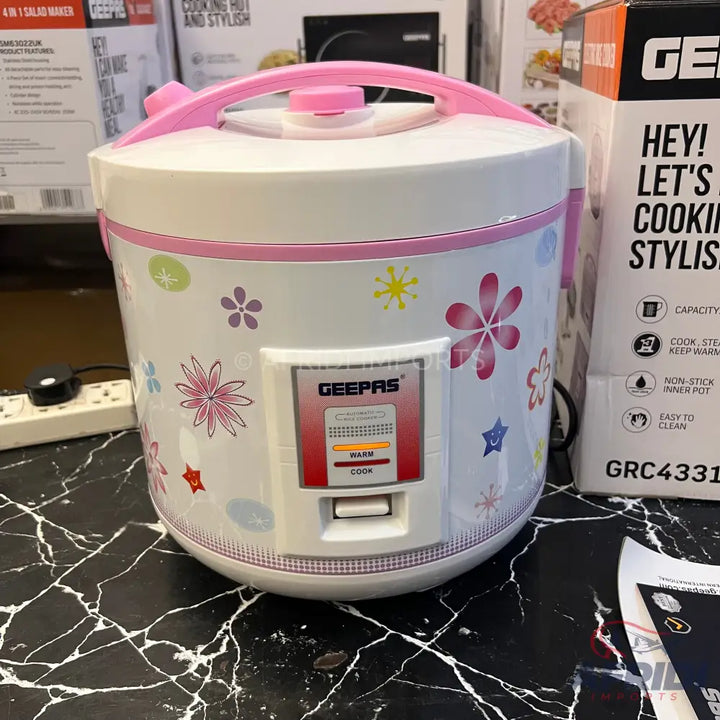 White rice cooker with a floral pattern and pink accents.
