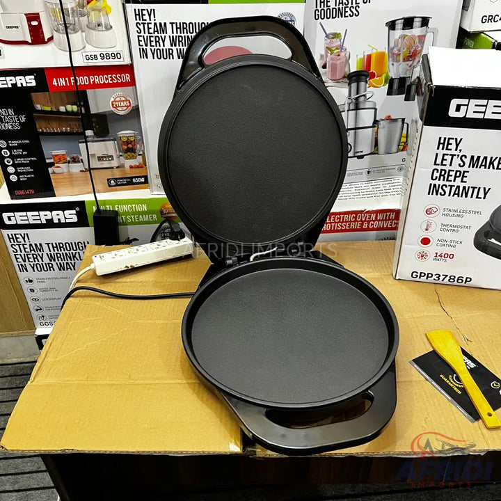 An open black electric crepe maker.