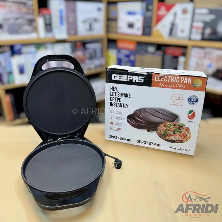 Black electric crepe maker with a non-stick coating and a hinged lid.