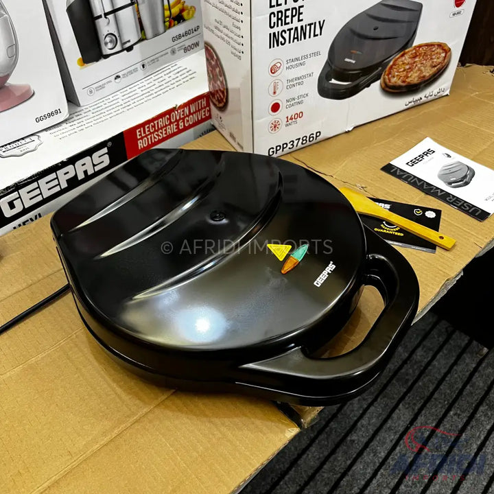 Black electric crepe maker with indicator lights.
