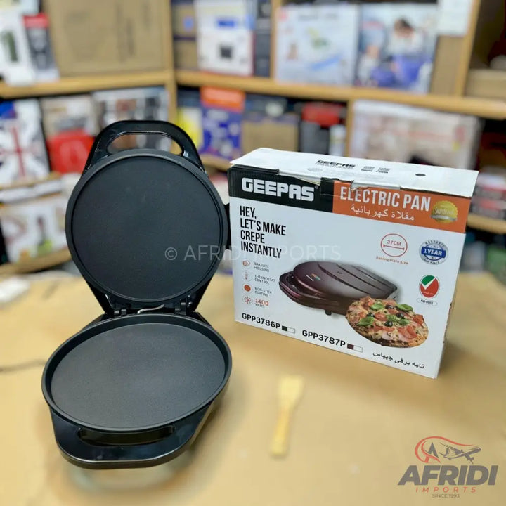Black electric crepe maker with a non-stick cooking surface.