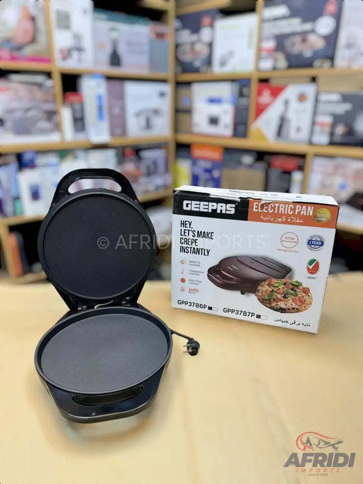 Black electric crepe maker with a non-stick cooking surface.