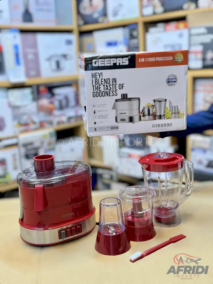 Red and silver 4-in-1 food processor with multiple attachments.