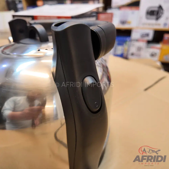 A shiny metal electric kettle with a black plastic handle and a power button.