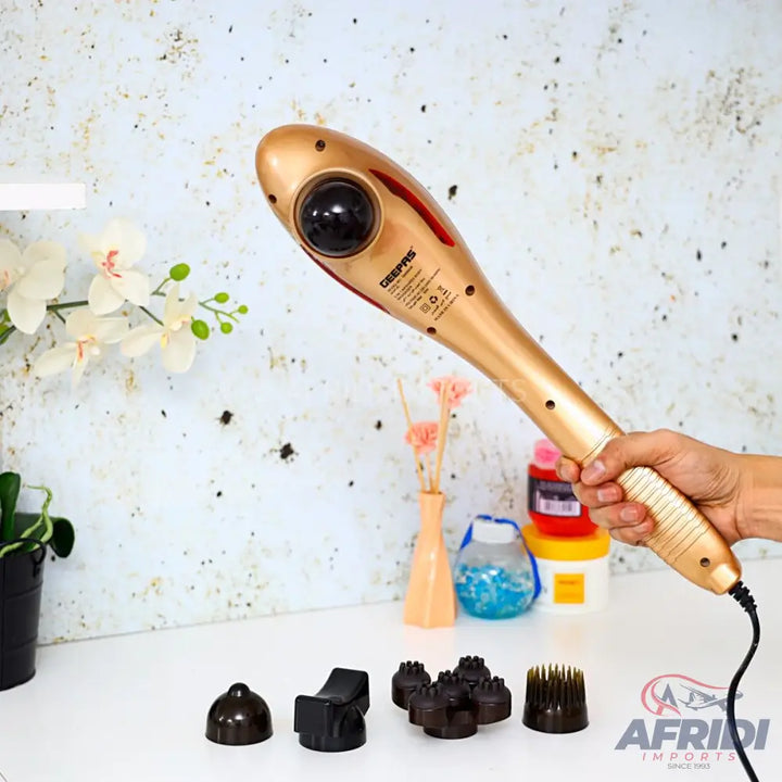 Gold-colored handheld electric massager with various interchangeable head attachments.