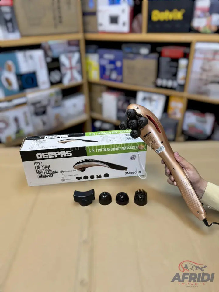 A rose gold handheld body massager with multiple interchangeable massage heads, suitable for professional therapy.